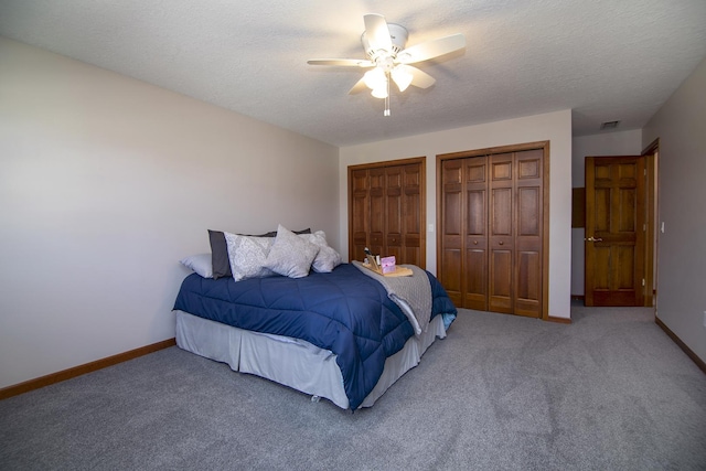 909 Revere St, Bourbonnais, IL 60914 - carpeted bedroom with a ceiling fan, a textured ceiling, multiple closets, baseboards, and visible vents