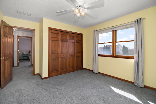 909 Revere St, Bourbonnais, IL 60914 - unfurnished bedroom with baseboards, a closet, a textured ceiling, and visible vents
