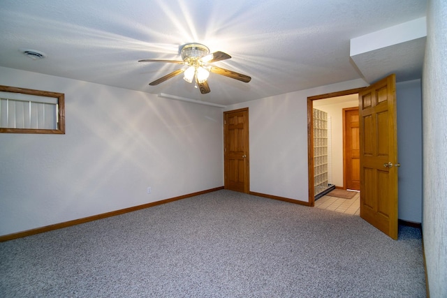 909 Revere St, Bourbonnais, IL 60914 - interior space with a ceiling fan, light carpet, a textured ceiling, baseboards, and visible vents