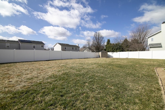 909 Revere St, Bourbonnais, IL 60914 - view of yard with a fenced backyard, a storage unit, and an outbuilding