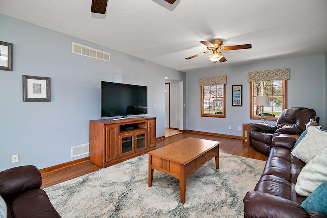 909 Revere St, Bourbonnais, IL 60914 - living room featuring baseboards, visible vents, wood finished floors, and ceiling fan