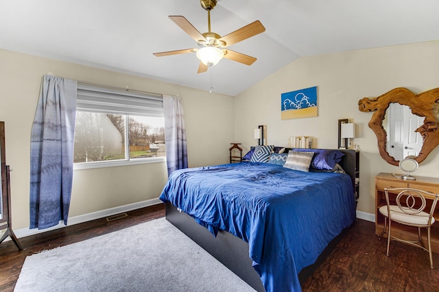 bedroom with baseboards, vaulted ceiling, and wood finished floors