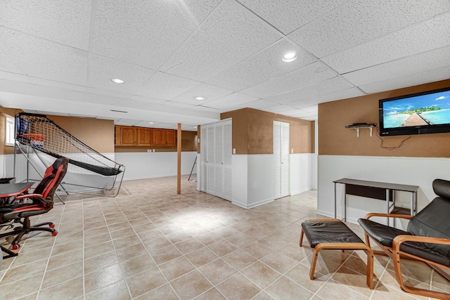 interior space with a wainscoted wall, recessed lighting, a paneled ceiling, and light tile patterned flooring
