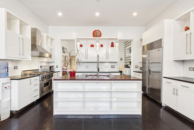 844 W Webster Ave, Chicago, IL 60614 - kitchen with dark countertops, high quality appliances, open shelves, and wall chimney exhaust hood