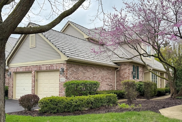 4517 S Seminole Dr, Glenview, IL 60026 - view of side of home with brick siding, a garage, and concrete driveway