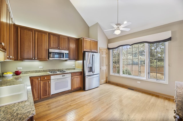 4517 S Seminole Dr, Glenview, IL 60026 - kitchen with a ceiling fan, appliances with stainless steel finishes, a sink, and light wood finished floors