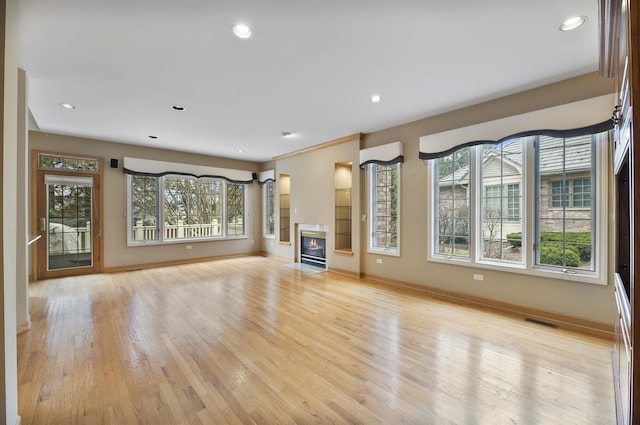 4517 S Seminole Dr, Glenview, IL 60026 - unfurnished living room featuring plenty of natural light, light wood-style flooring, baseboards, and visible vents