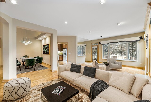 4517 S Seminole Dr, Glenview, IL 60026 - living area featuring a notable chandelier, light wood finished floors, arched walkways, recessed lighting, and baseboards