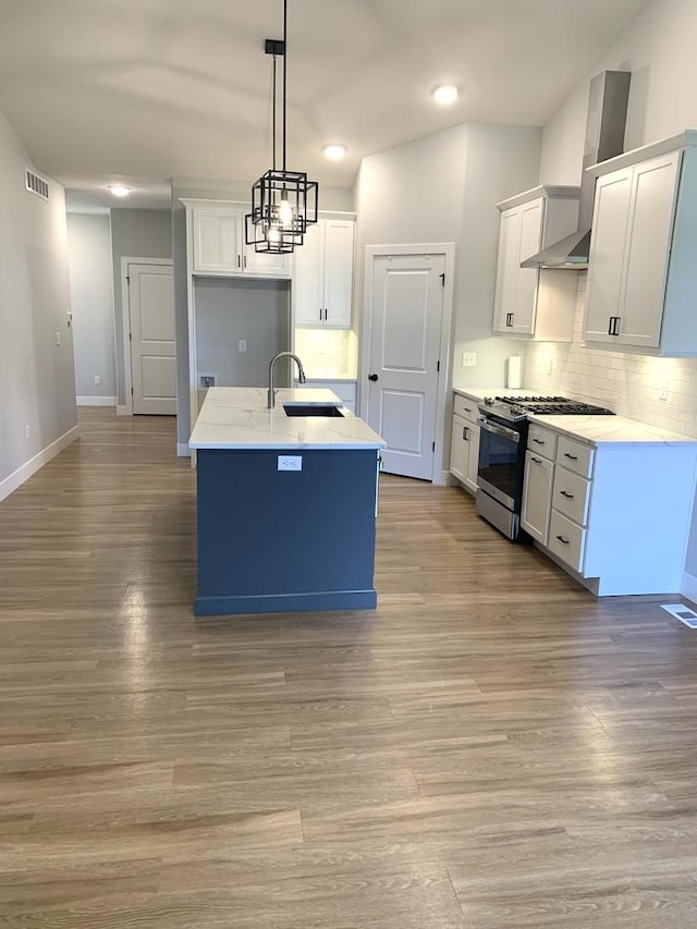 1805 Glenbridge Rd, Bloomington, IL 61704 - kitchen with a sink, stainless steel gas stove, light wood-style flooring, backsplash, and visible vents