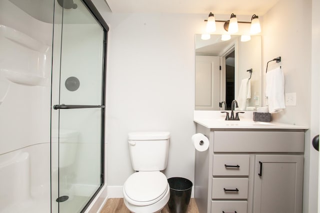 1805 Glenbridge Rd, Bloomington, IL 61704 - bathroom featuring toilet, baseboards, wood finished floors, a shower stall, and vanity