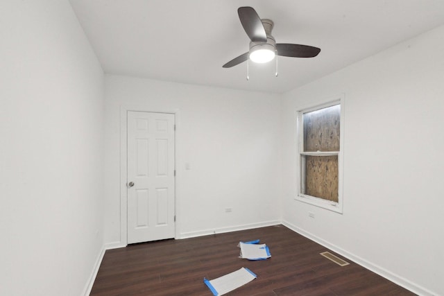 empty room featuring baseboards, visible vents, a ceiling fan, and wood finished floors
