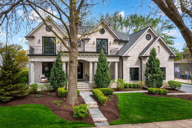 1017 Royal Bombay Ct, Naperville, IL 60563 - view of front of house with a balcony, stone siding, a porch, and a front lawn