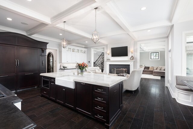 1017 Royal Bombay Ct, Naperville, IL 60563 - kitchen with light stone countertops, coffered ceiling, decorative light fixtures, beam ceiling, and dark wood-style floors