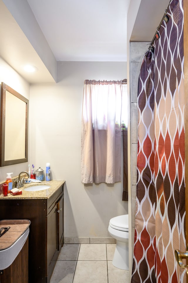9724 S Princeton Ave, Chicago, IL 60628 - bathroom with vanity, toilet, tile patterned floors, and baseboards