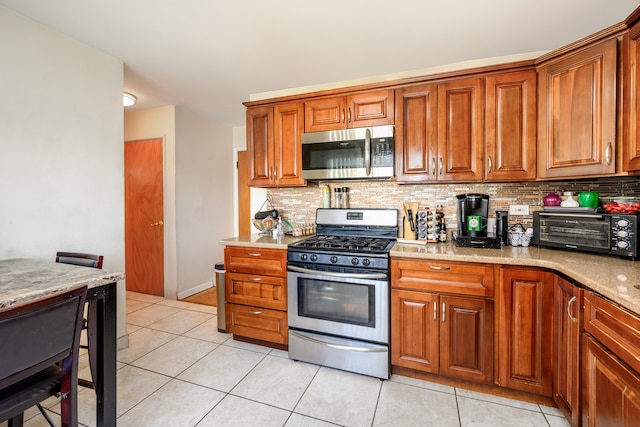 9724 S Princeton Ave, Chicago, IL 60628 - kitchen with stainless steel appliances, backsplash, and brown cabinetry