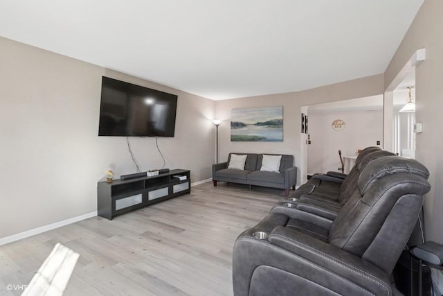 living room with light wood finished floors and baseboards