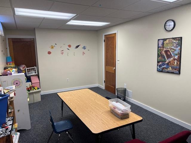 office area featuring a drop ceiling, carpet floors, and baseboards