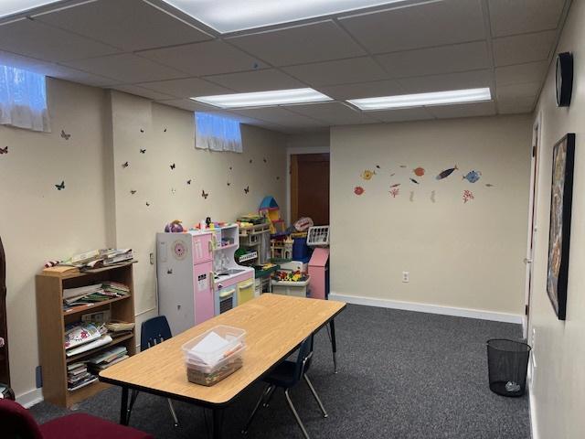 playroom with baseboards, carpet flooring, and a paneled ceiling