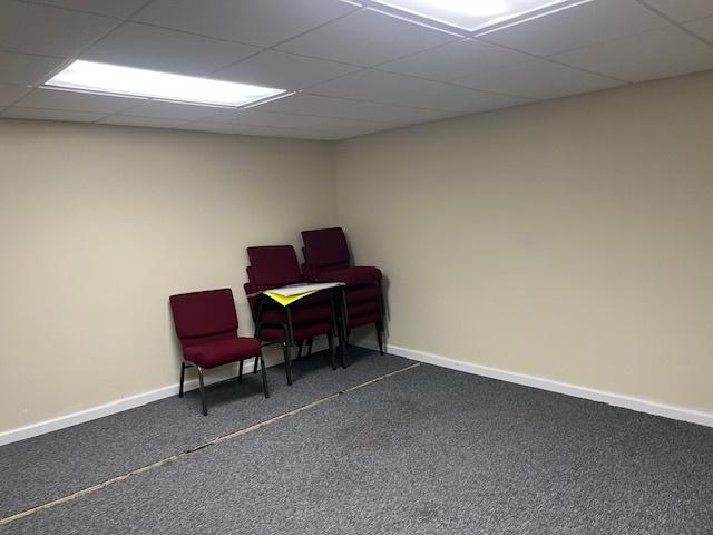 sitting room with baseboards, carpet flooring, and a paneled ceiling