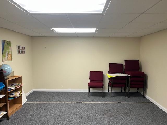 sitting room featuring baseboards and a drop ceiling