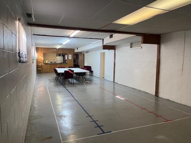 basement with concrete block wall and visible vents