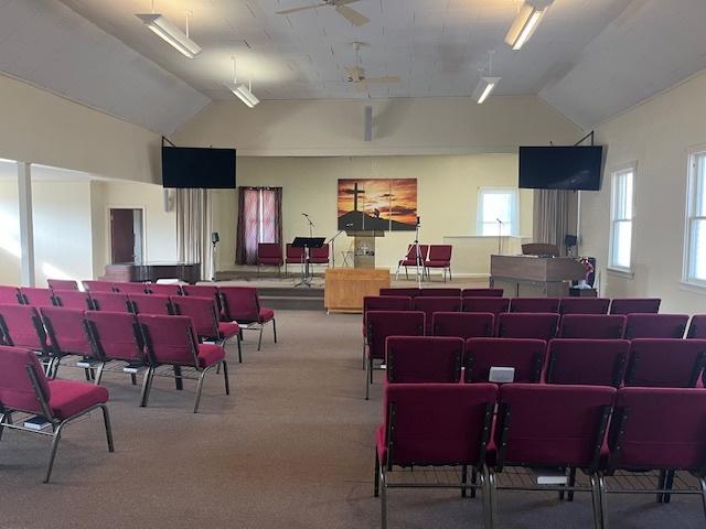 misc room with vaulted ceiling and carpet flooring