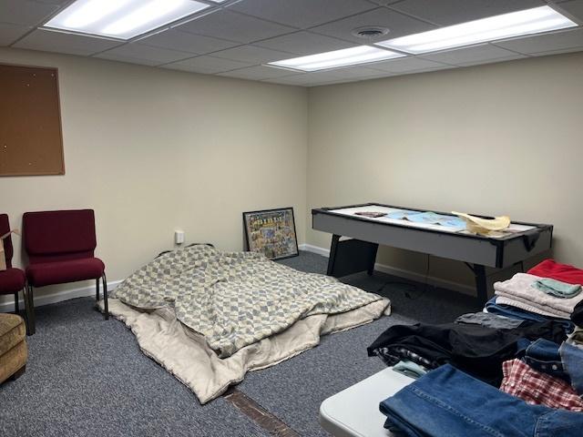 rec room featuring baseboards, carpet floors, and a paneled ceiling