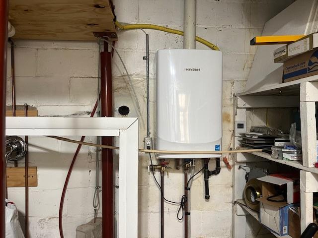 utility room with tankless water heater
