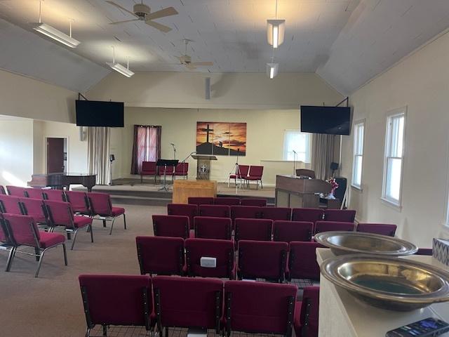 misc room with carpet flooring, ceiling fan, and vaulted ceiling