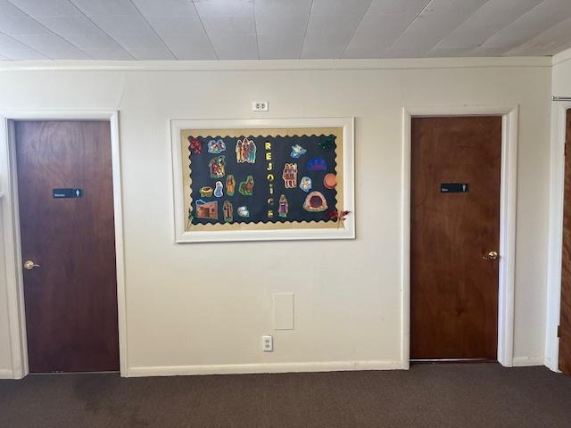 interior space with baseboards and dark colored carpet