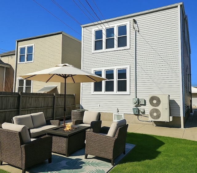back of house featuring fence, an outdoor living space with a fire pit, ac unit, and a patio area