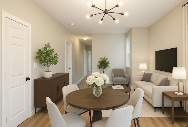 dining space featuring light wood-type flooring, baseboards, and a chandelier