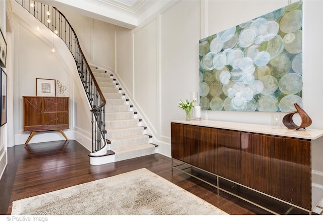 1853 N Burling St, Chicago, IL 60614 - foyer with wood finished floors, stairs, a decorative wall, and crown molding