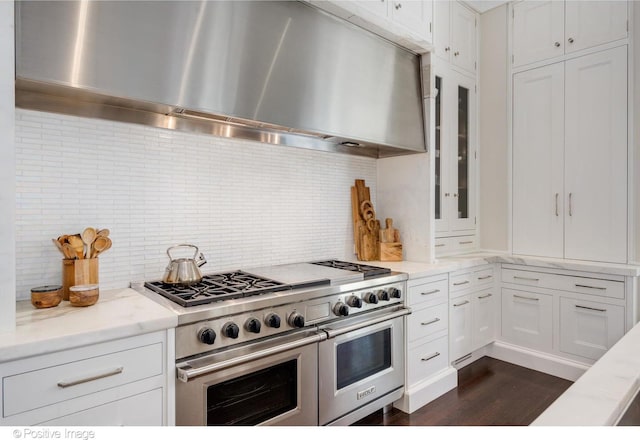 1853 N Burling St, Chicago, IL 60614 - kitchen with island exhaust hood, range with two ovens, backsplash, and dark wood-style flooring