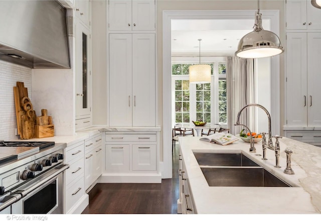 1853 N Burling St, Chicago, IL 60614 - kitchen featuring a sink, wall chimney exhaust hood, dark wood finished floors, stainless steel stove, and white cabinets