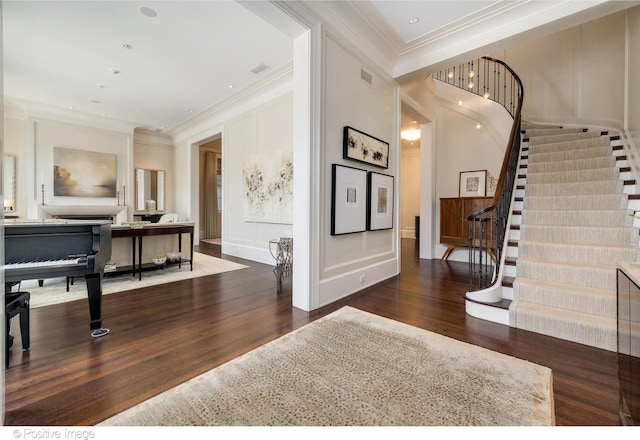 1853 N Burling St, Chicago, IL 60614 - foyer featuring wood finished floors, stairs, ornamental molding, and a decorative wall