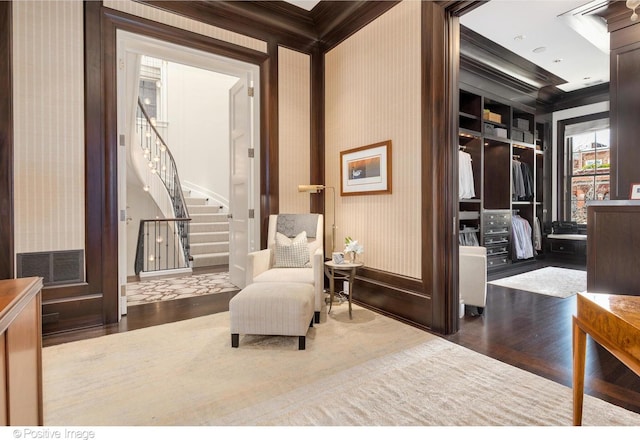 1853 N Burling St, Chicago, IL 60614 - living area featuring wallpapered walls, wood finished floors, crown molding, stairs, and baseboards
