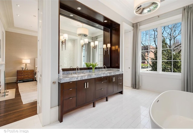 1853 N Burling St, Chicago, IL 60614 - full bathroom featuring a freestanding bath, double vanity, crown molding, and baseboards