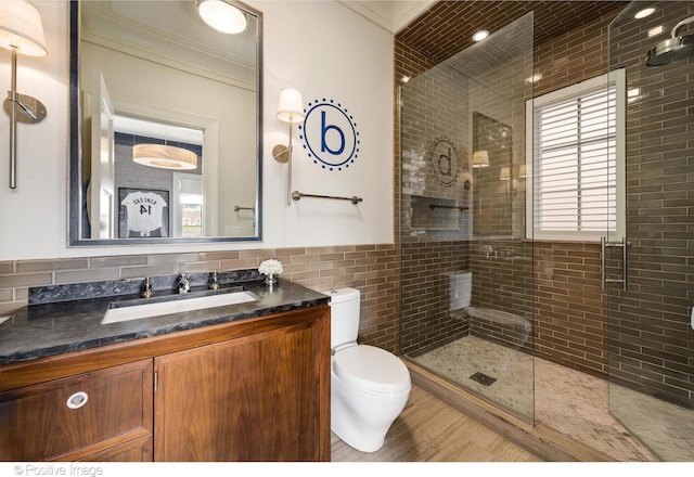 1853 N Burling St, Chicago, IL 60614 - bathroom with toilet, tile walls, a tile shower, vanity, and crown molding