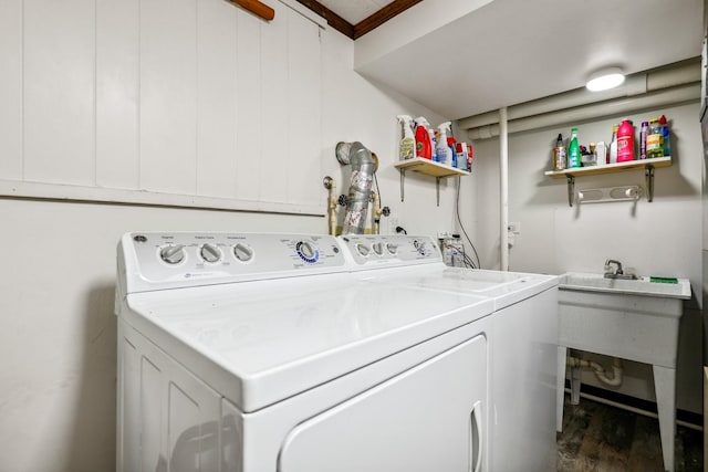 washroom with wood finished floors, laundry area, and separate washer and dryer