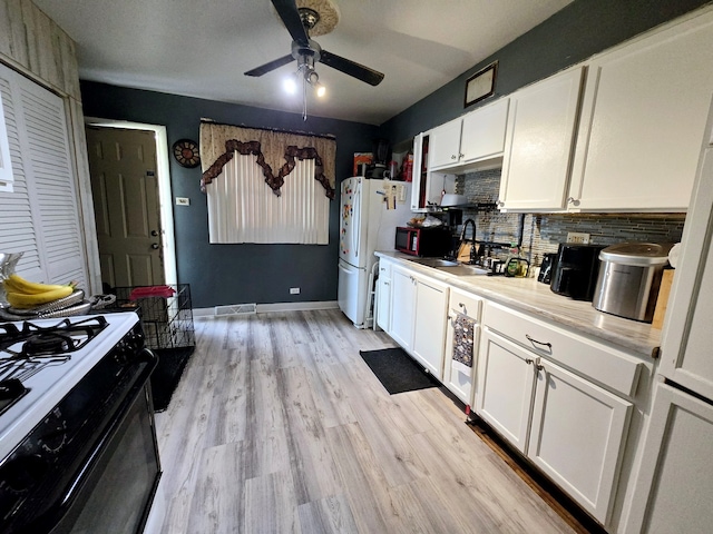 15516 Dorchester Ave, Dolton, IL 60419 - kitchen featuring a sink, white cabinetry, ceiling fan, gas stove, and decorative backsplash