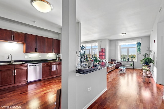500 E St Charles Rd Unit 510, Lombard, IL 60148 - kitchen with dark countertops, a sink, open floor plan, wood finished floors, and stainless steel dishwasher