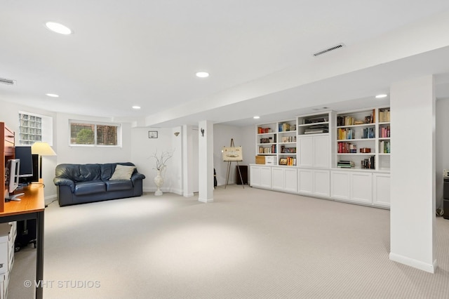 living room with visible vents, baseboards, and light colored carpet
