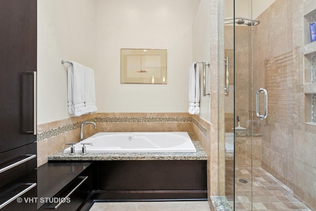 full bath featuring a bath and a stall shower