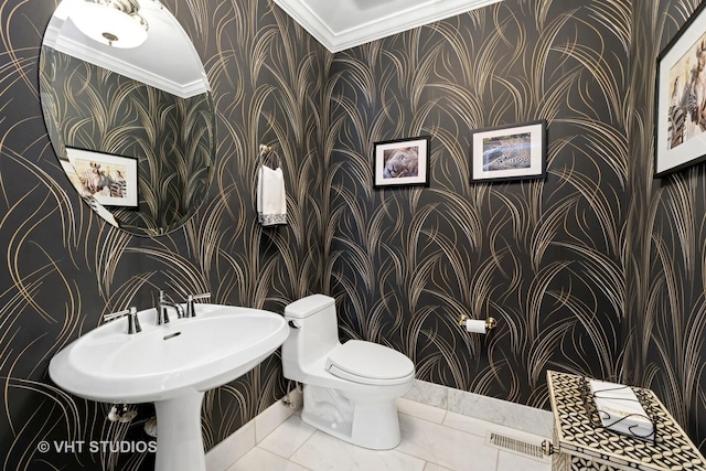 half bath featuring ornamental molding, visible vents, toilet, and wallpapered walls