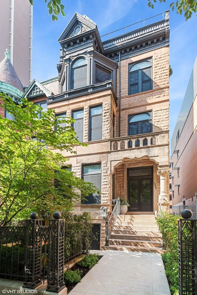 view of front of property featuring french doors and fence