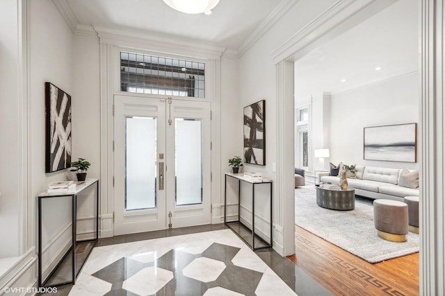 entryway with baseboards, wood finished floors, french doors, and crown molding