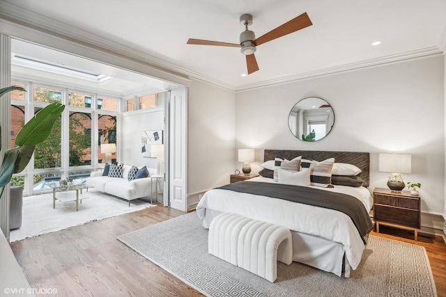 bedroom with baseboards, ornamental molding, wood finished floors, ceiling fan, and recessed lighting