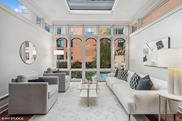 living room featuring plenty of natural light, crown molding, and floor to ceiling windows