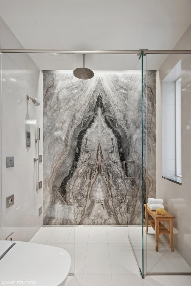 bathroom with tile patterned flooring and a marble finish shower